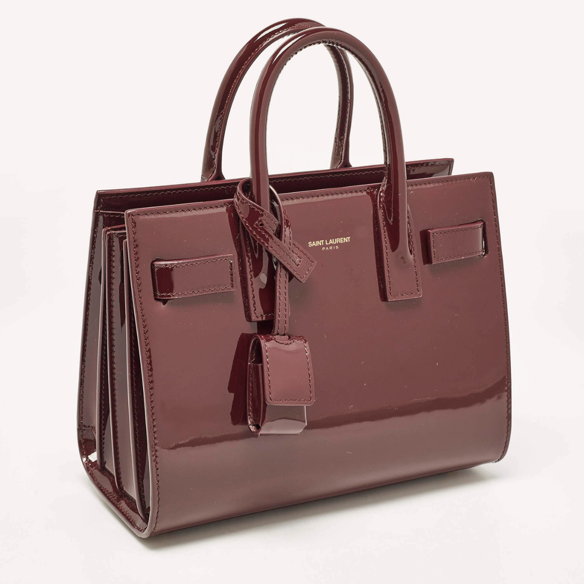 YVES SAINT LAURENT SAC DE JOUR NANO EN CUIR VERNI
